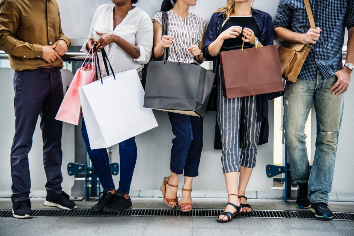 a group of people holding shopping bags